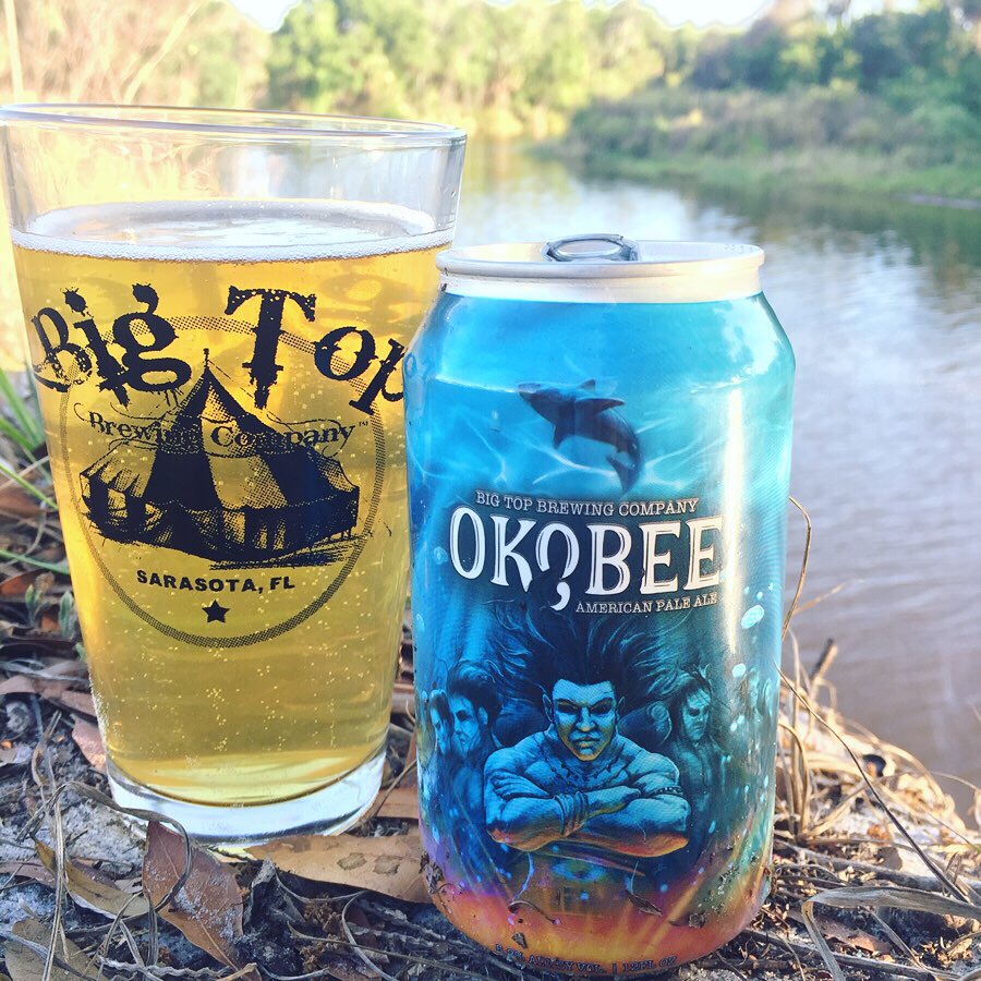 Okobee Pale Ale poured in a Big Top Brewing glass with the can by the Manatee River